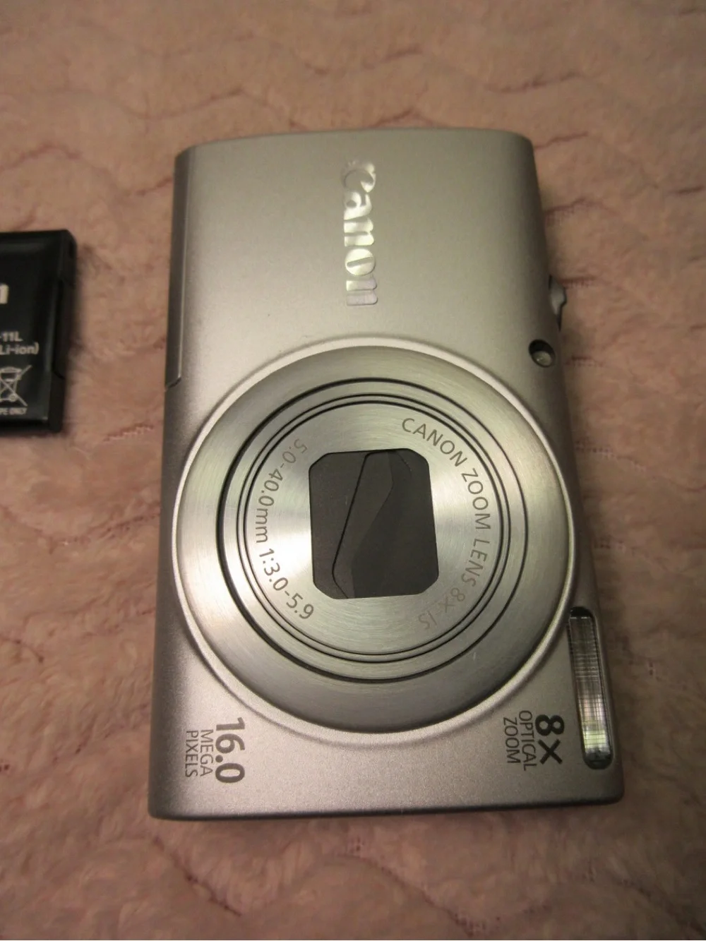Canon Silver Compact Camera with Black Charger and Accessories